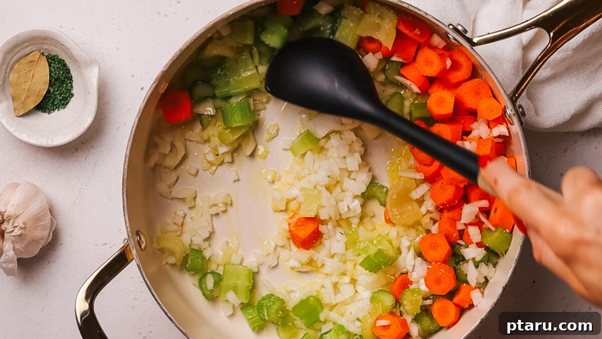 Effortless Ham and Bean Soup: Seriously Delicious and Satisfying 4 Step 1: Sautéing diced onions, carrots, and celery in olive oil in a large pot.