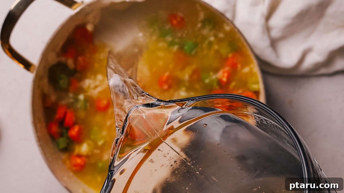 Effortless Ham and Bean Soup: Seriously Delicious and Satisfying 5 Step 2: Adding minced garlic and diced ham to the sautéed vegetables in the pot.