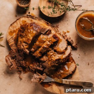 Instant Pot Roast Beef on a cutting board with a bowl of gravy.