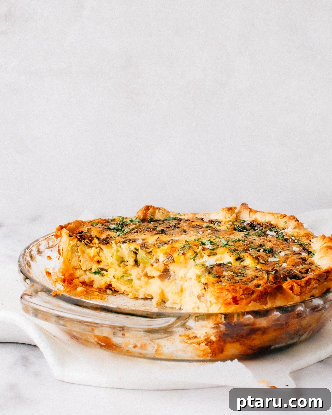 Simply Delicious Spinach Mushroom Quiche 5 A slice of Spinach Mushroom Quiche on a plate, ready to serve.