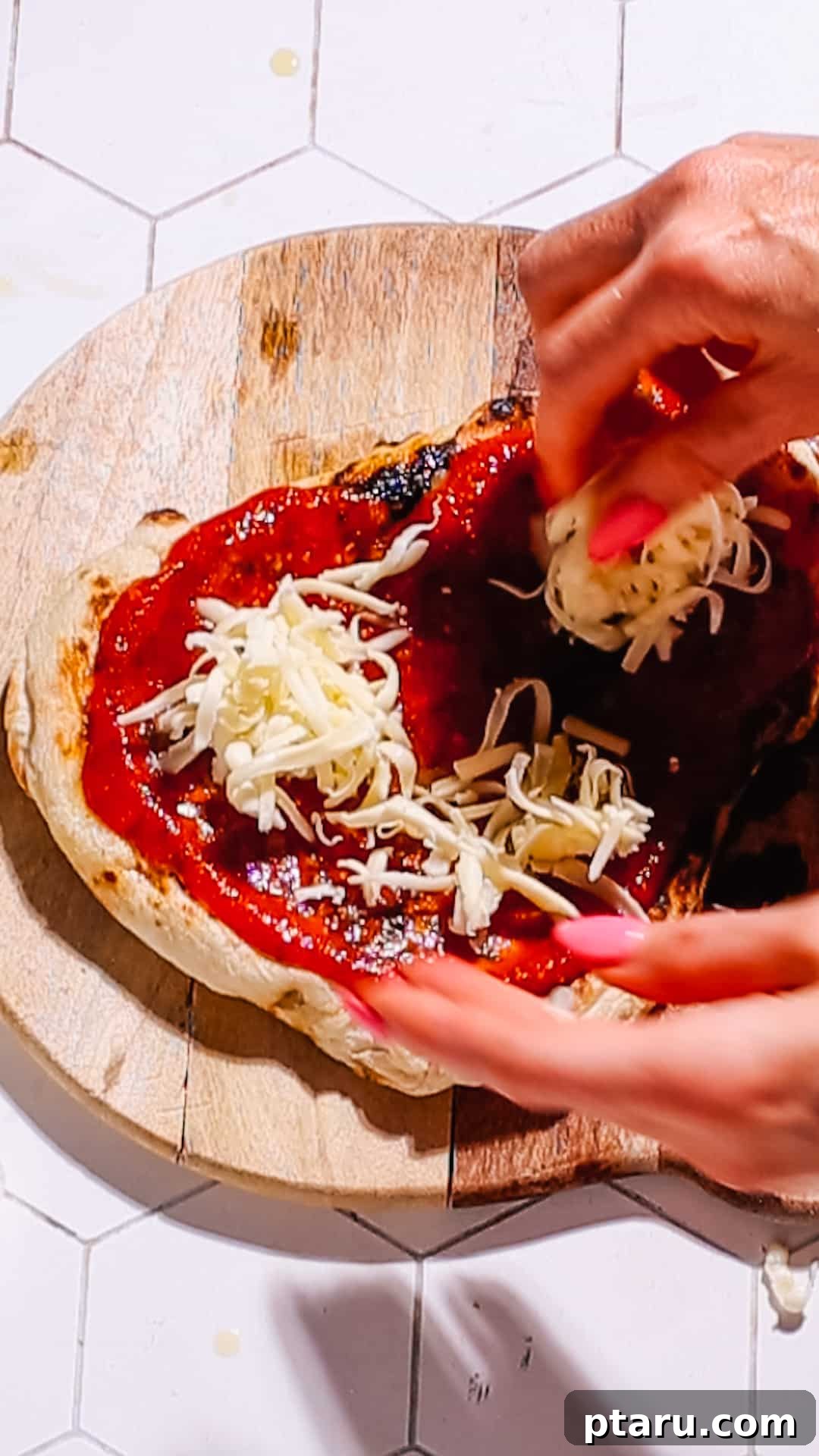 10-Minute Flatbread Pizza Magic 4 Adding shredded cheese to a naan pizza base