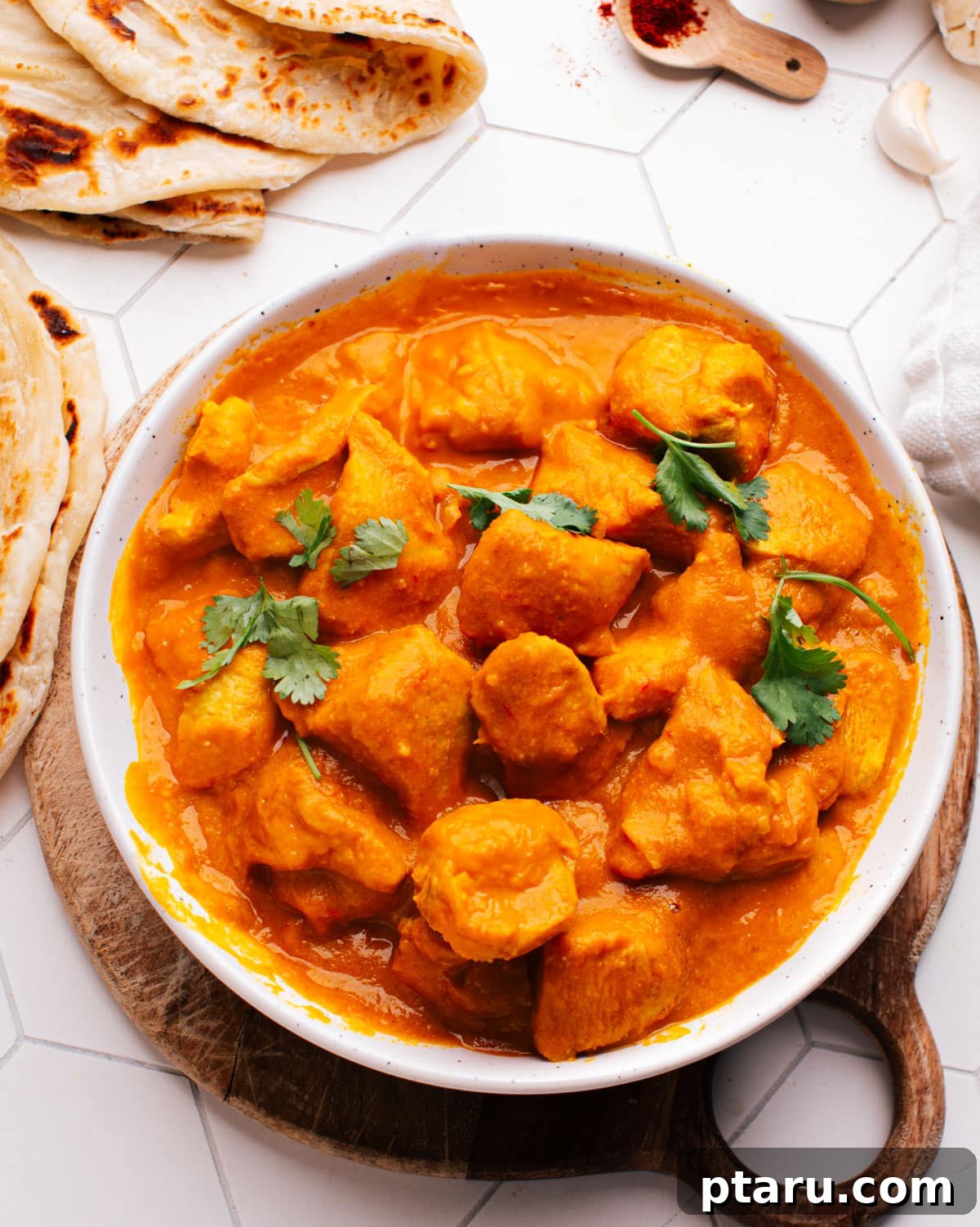 28 Plus Healthy Chicken Recipes Made Easy Delicious and Dietitian Endorsed 12 Healthy Chicken recipes showing a bowl of creamy coconut curry chicken, garnished with fresh herbs.