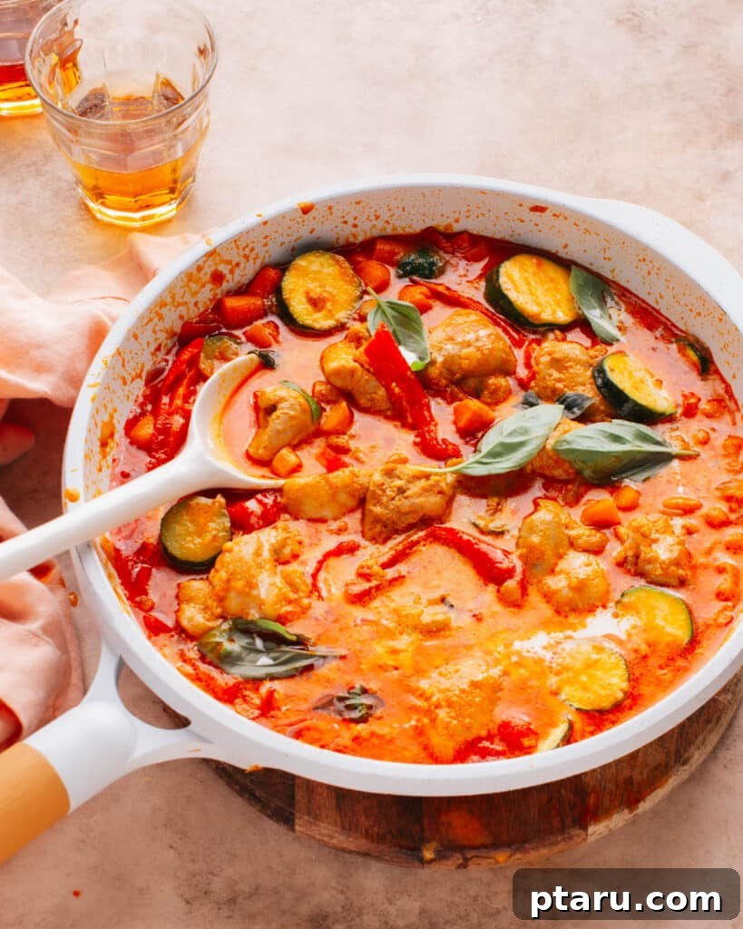 28 Plus Healthy Chicken Recipes Made Easy Delicious and Dietitian Endorsed 14 Spicy and creamy Thai Red Curry Chicken in a bowl, garnished with fresh basil leaves.