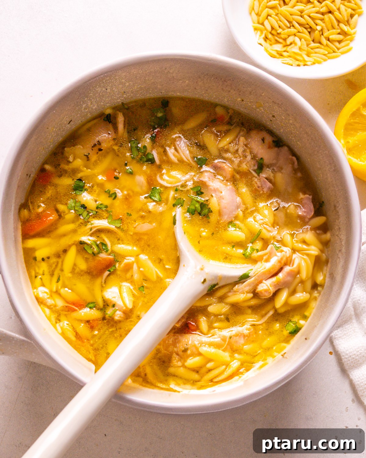 28 Plus Healthy Chicken Recipes Made Easy Delicious and Dietitian Endorsed 24 Traditional Greek Lemon Chicken Orzo Soup, served in a white bowl.