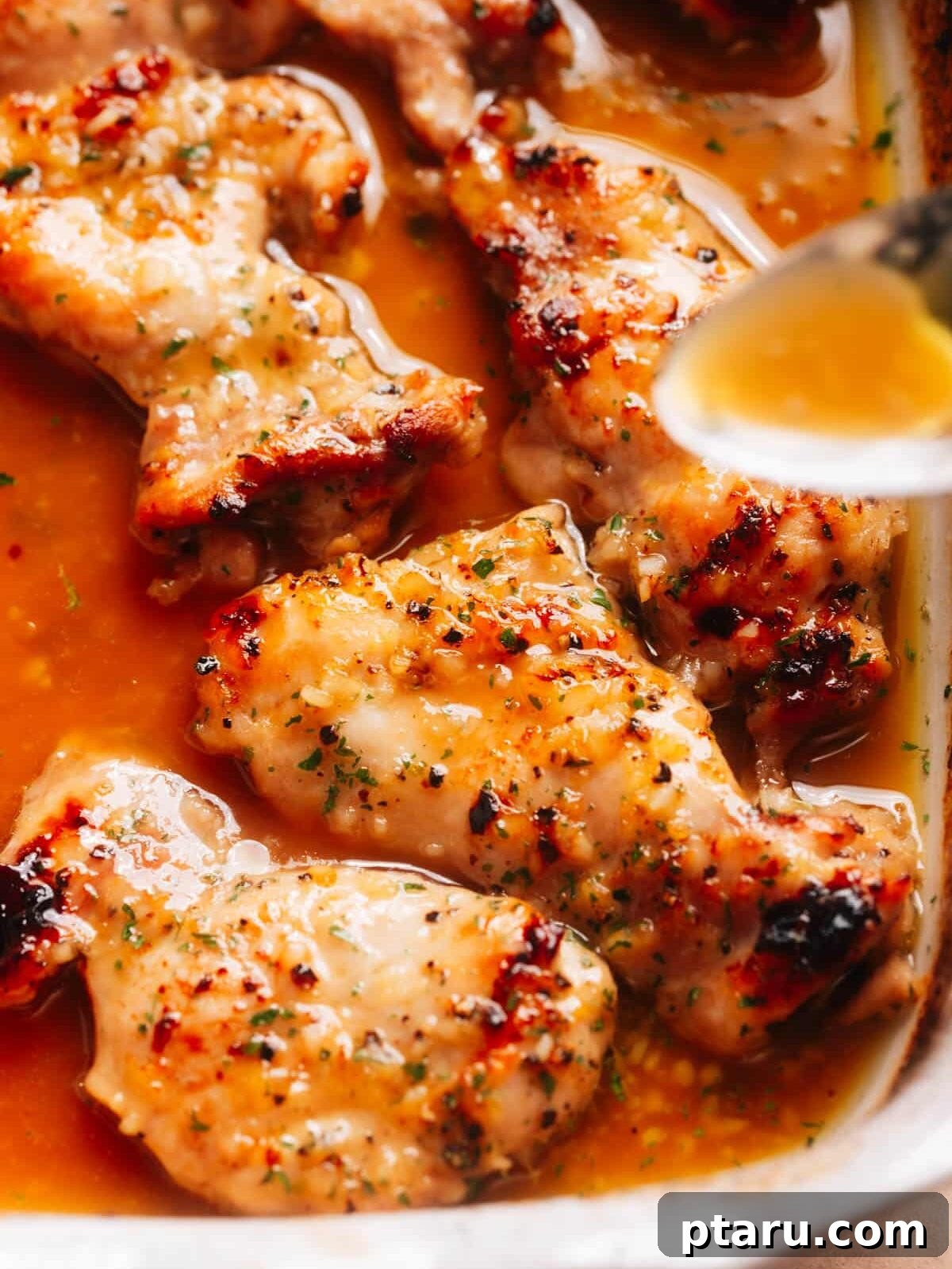 28 Plus Healthy Chicken Recipes Made Easy Delicious and Dietitian Endorsed 6 Succulent Honey Garlic Lemon Pepper Chicken Thighs glistening on a plate.