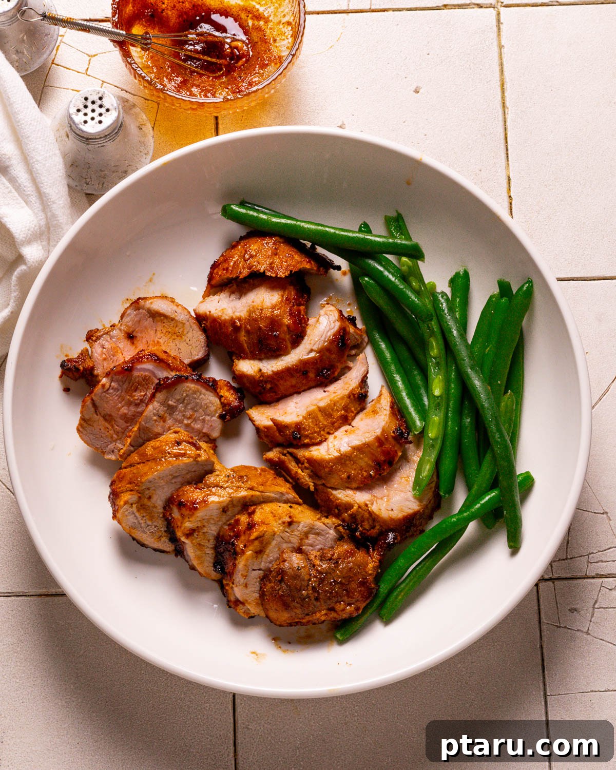 Air Fryer Pork Tenderloin Unbelievably Tender 11 Sliced air fryer pork tenderloin medallions drizzled with pan juices, ready to be served.