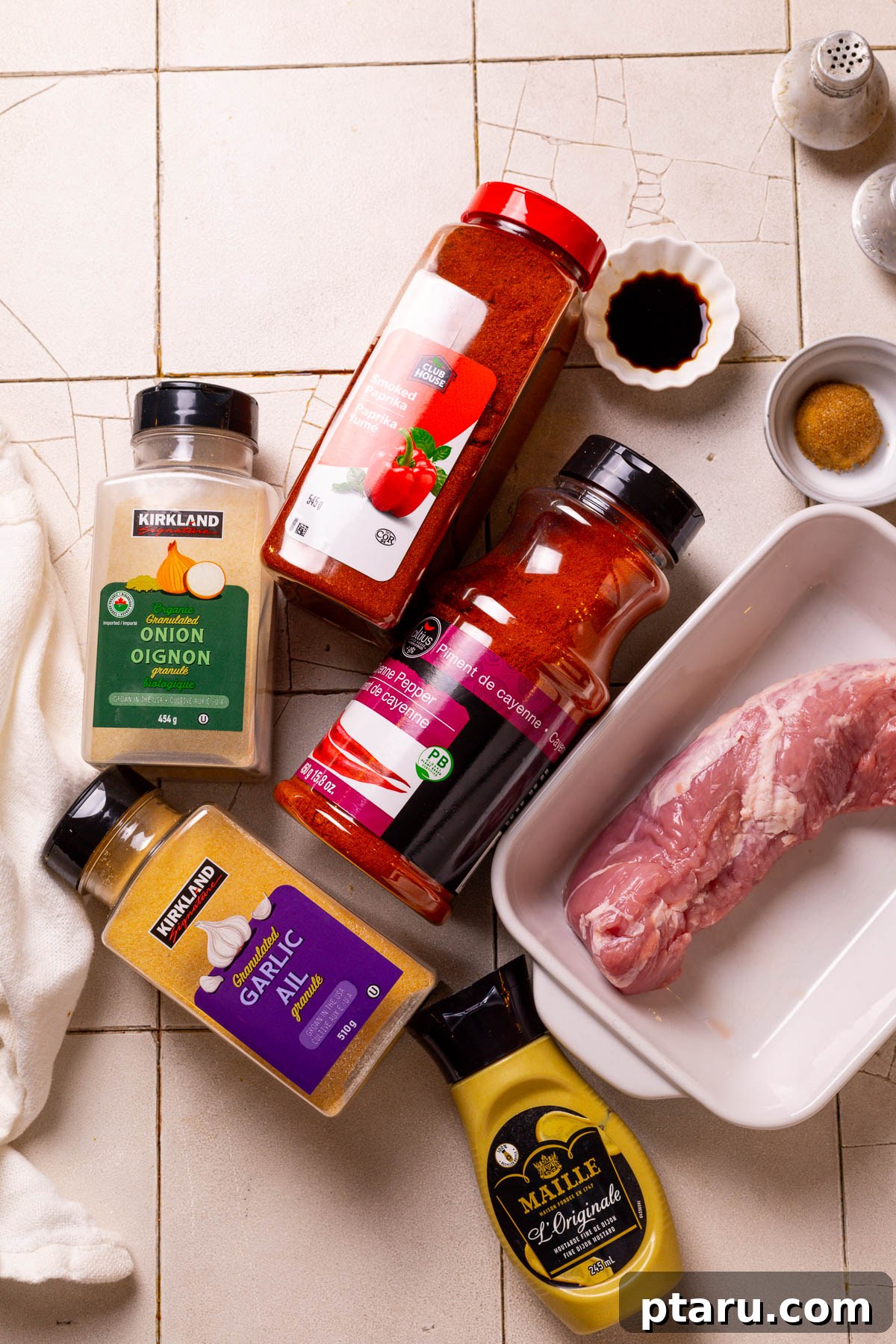 Air Fryer Pork Tenderloin Unbelievably Tender 3 All ingredients laid out for making Air Fryer Pork Tenderloin including spices, oils, and the raw pork.