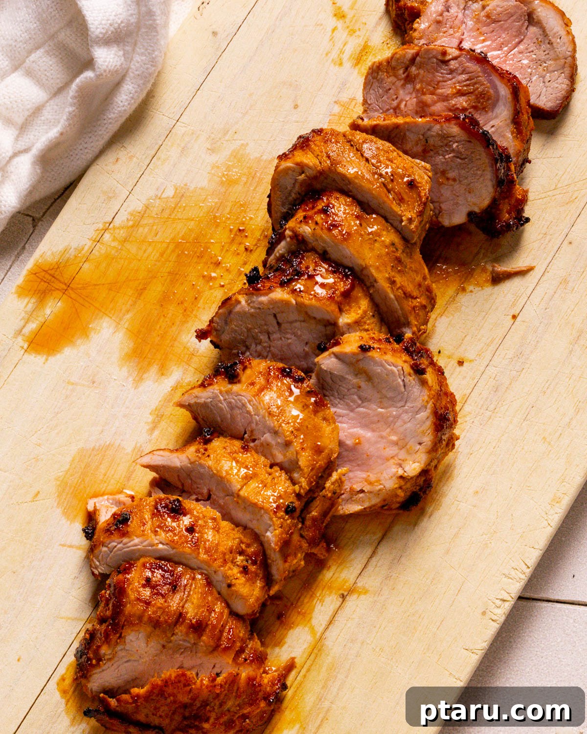 Air Fryer Pork Tenderloin Unbelievably Tender 10 Slicing the rested air fryer pork tenderloin into tender medallions, showing its juicy interior.