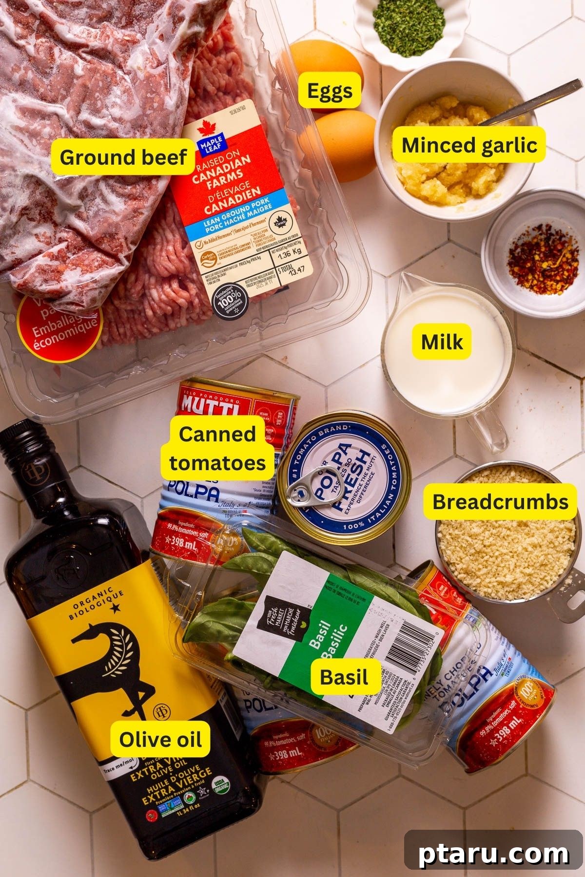 The Secret to Irresistible Meatballs 3 A vibrant flat lay of all the fresh ingredients needed for the best meatball recipe, including tomatoes, basil, ground meat, and breadcrumbs.
