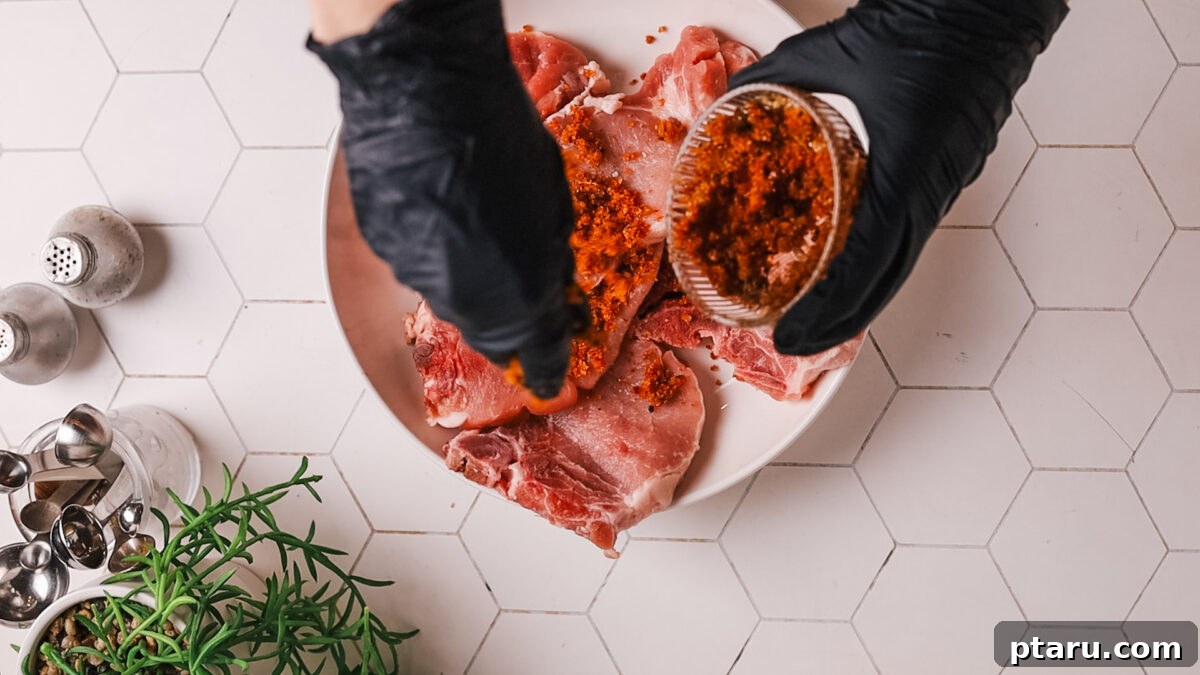 Tender Juicy Air Fryer Pork Chops Guaranteed 6 Applying rub on pork chop