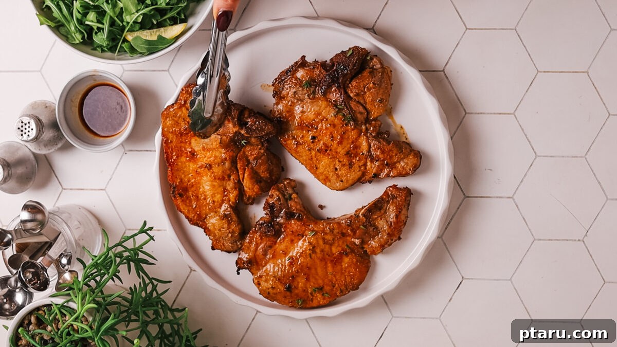 Tender Juicy Air Fryer Pork Chops Guaranteed 9 Pork chop on a plate ready to serve