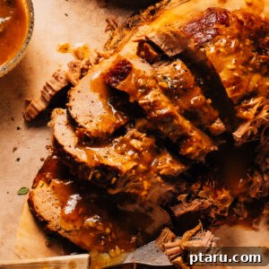 Hearty Dutch Oven Braised Beef 9 Dutch oven pot roast on a cutting board with a fork, ready to be served.