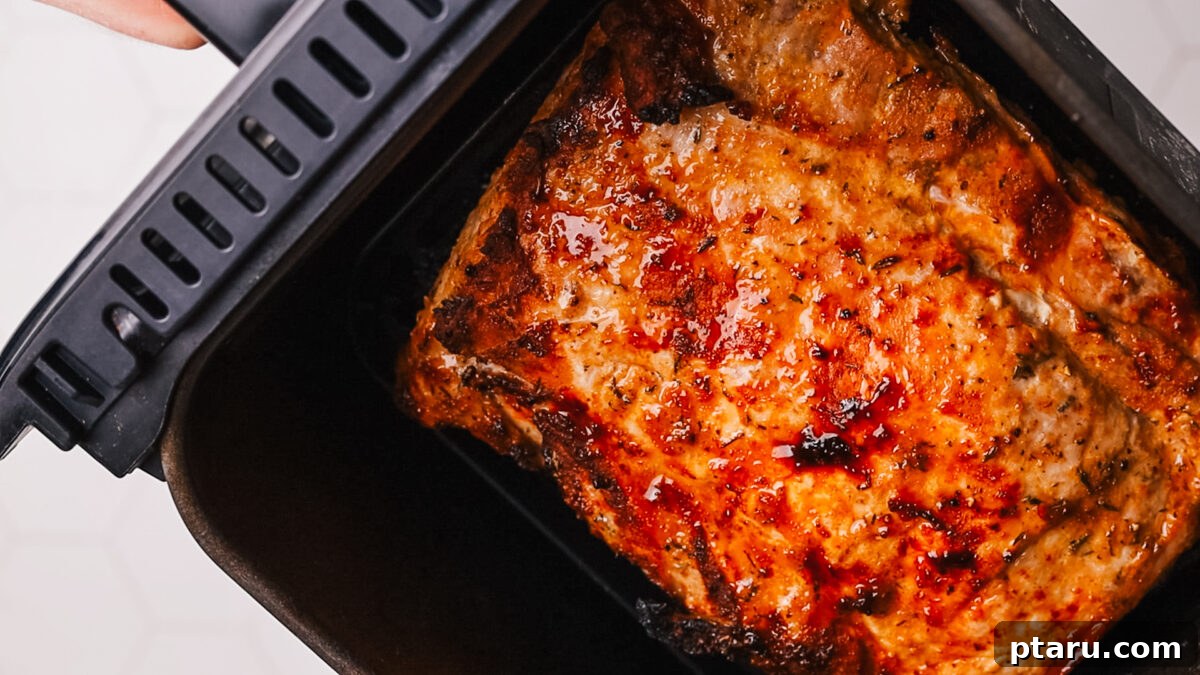 Air Fryer Pork Loin Perfection 7 adding pork in air fryer