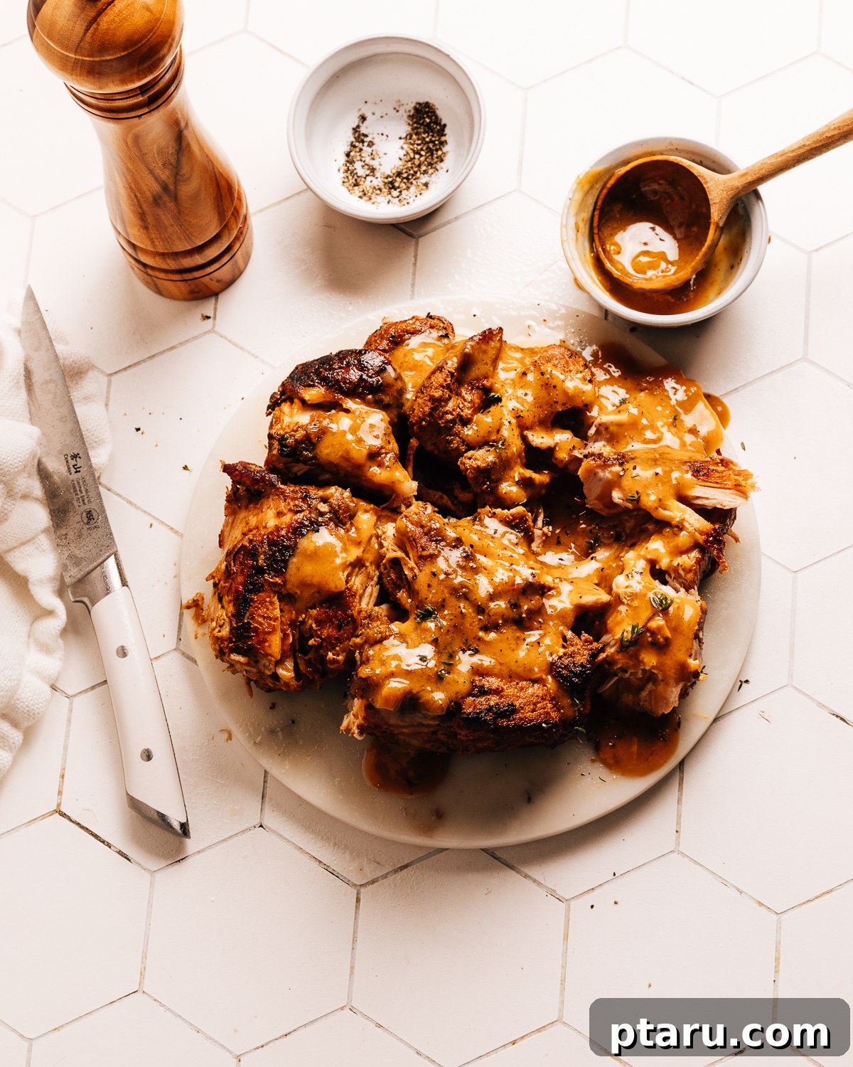 Fall-Apart Tender Instant Pot Pork Loin with an Irresistible Pan Sauce 2 Instant Pot pork loin on a plate with gravy.