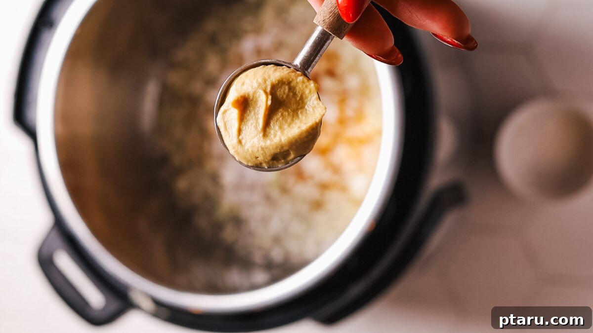 Fall-Apart Tender Instant Pot Pork Loin with an Irresistible Pan Sauce 8 adding mustard