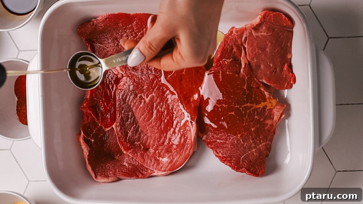 The Ultimate Recipe for Succulent Beef Fajitas 4 Steak marinating in a bowl with fajita spices and liquids, showing the rich color of the marinade.