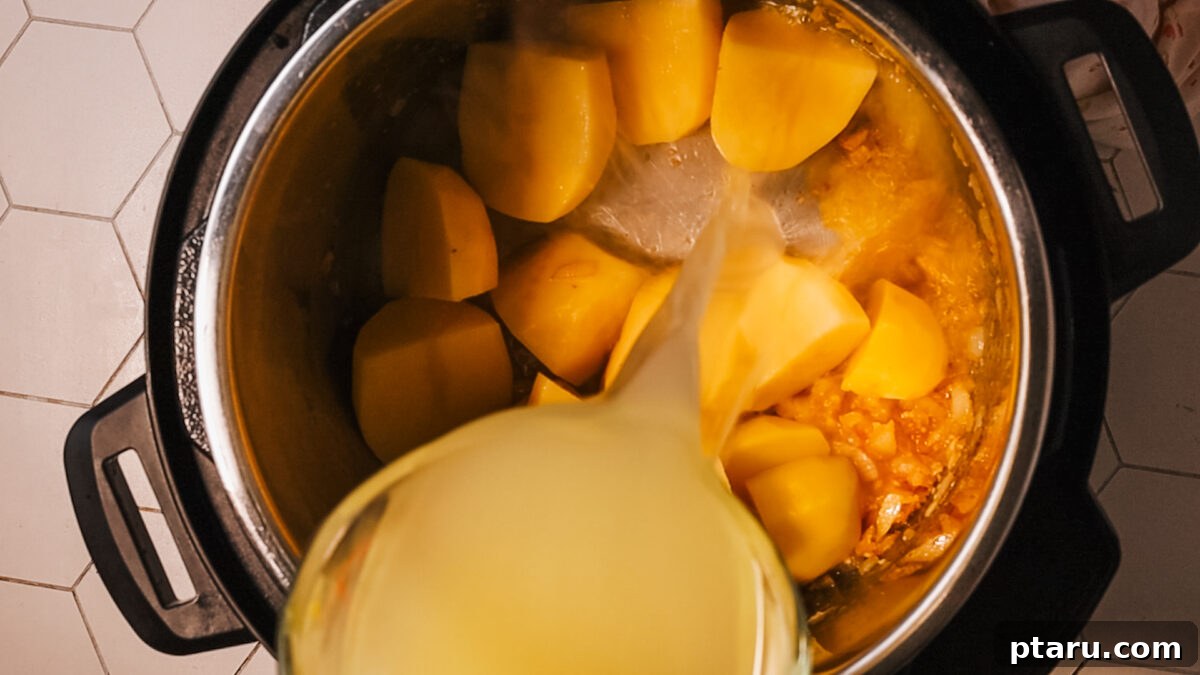 Creamy Instant Pot Potato Soup Ready in Minutes 7 adding potato and broth