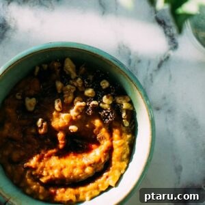 Carrot Cake Slow-Cooker Steel-Cut Oats, topped with nuts and cream.