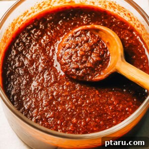 Nashville hot sauce with a spoon.