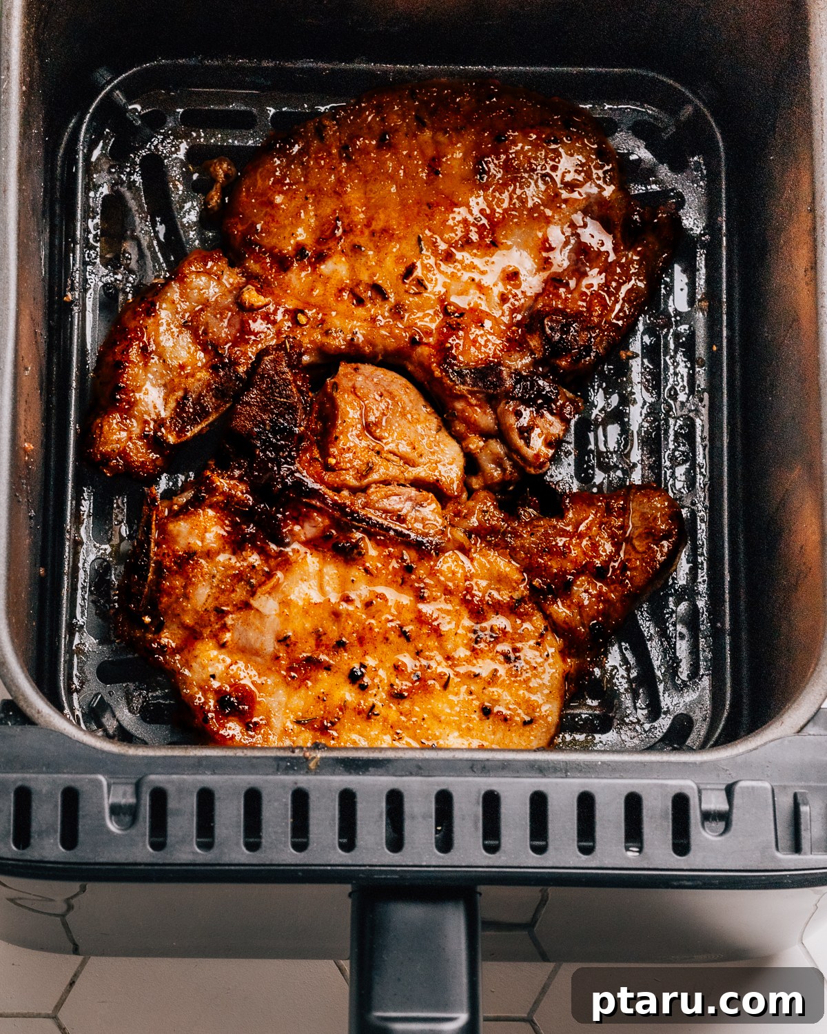 Over 60 Irresistible Recipes for Your Easter Feast 14 Perfectly cooked Air Fryer Pork Chops, ready to be served.