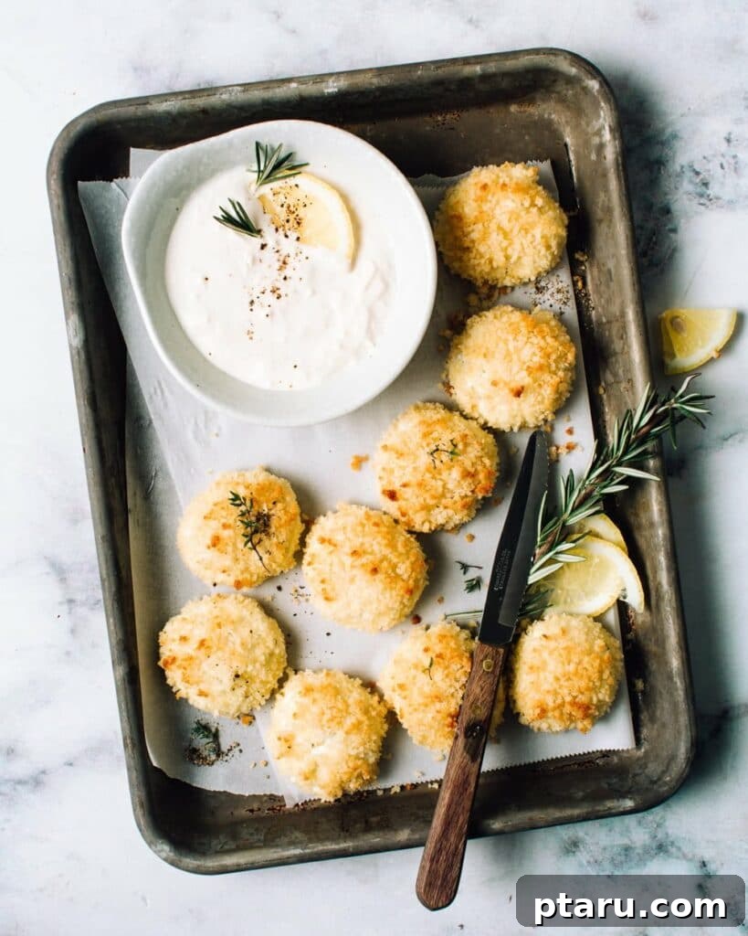 Over 60 Irresistible Recipes for Your Easter Feast 4 Crispy Baked Goat Cheese Fritters, garnished with fresh herbs.