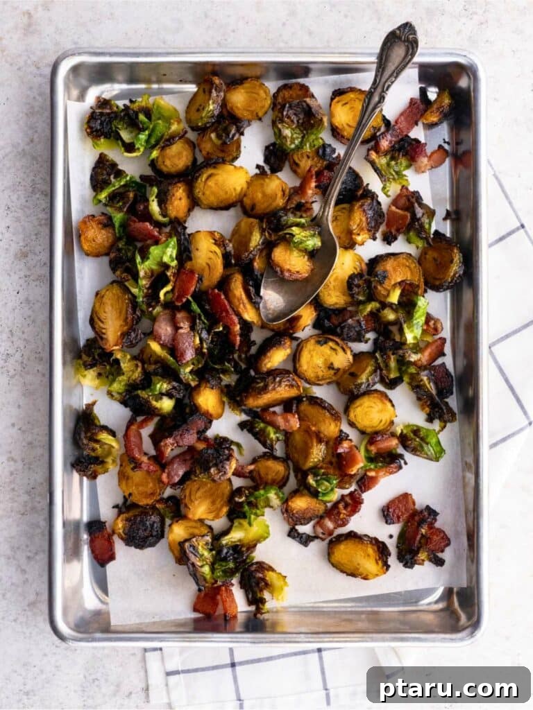 Over 60 Irresistible Recipes for Your Easter Feast 34 Crispy Roasted Brussels Sprouts with Maple and Bacon on a parchment-lined baking sheet.