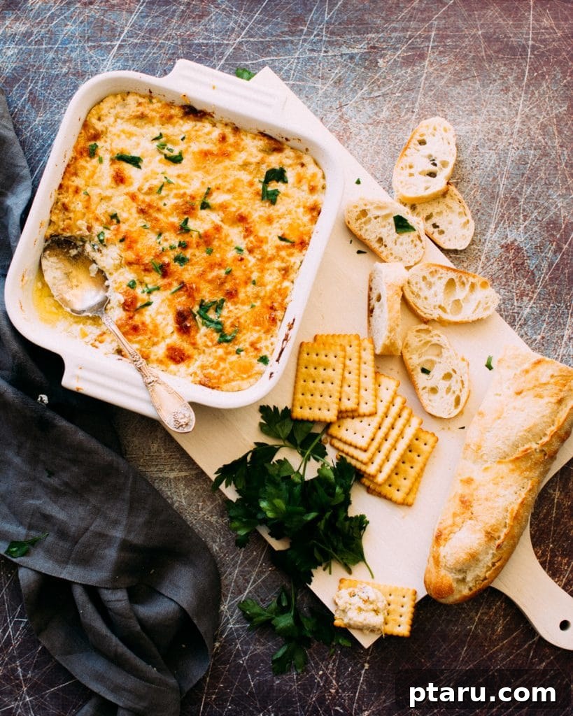 Over 60 Irresistible Recipes for Your Easter Feast 10 Creamy Hot Artichoke and Shrimp Dip, served in a rustic bowl.