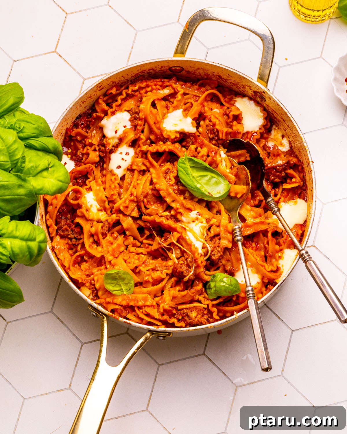 Sauce Simmered Pasta Perfection 2 Delicious one-pot pasta with meat sauce served in a large bowl with two spoons, ready to be enjoyed.