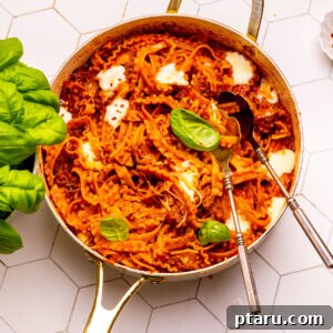 One Pot Pasta with two spoons. A close-up view of the finished dish with spoons ready to serve.