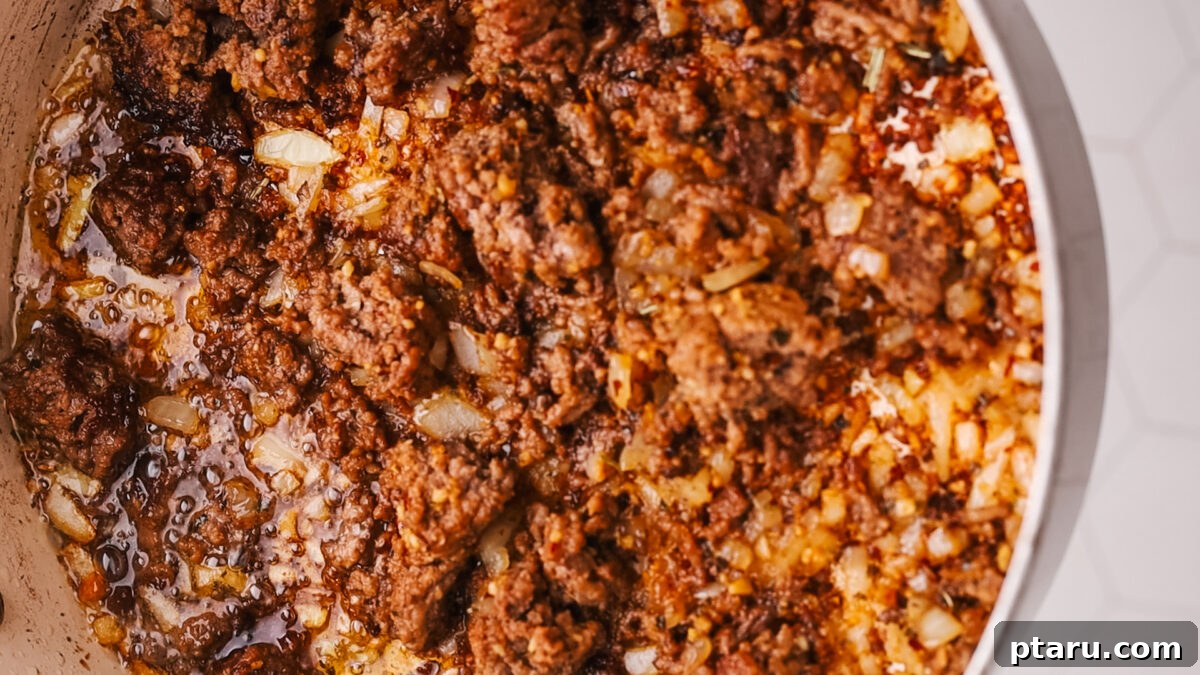 Sauce Simmered Pasta Perfection 7 Fully cooked ground beef and softened onions ready for the next step.