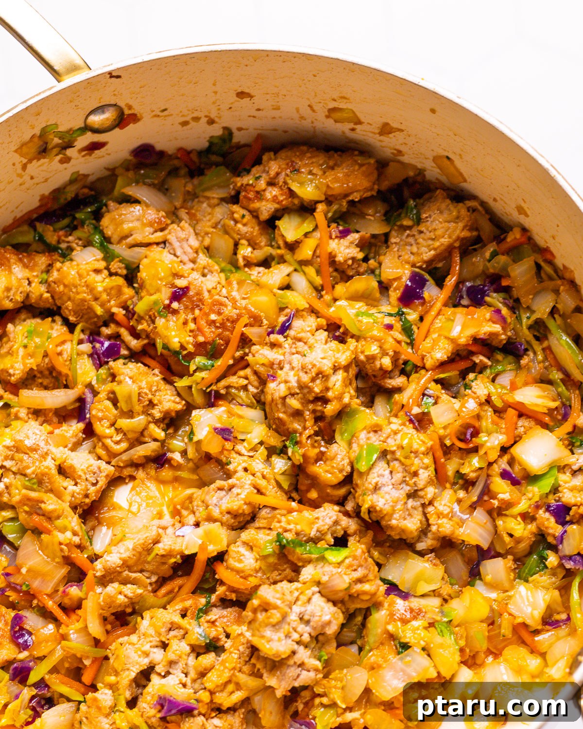 Quick Fix Egg Roll Bowl 4 Egg Roll in a Bowl cooking in a large skillet, showing ground meat and vegetables stir-frying.
