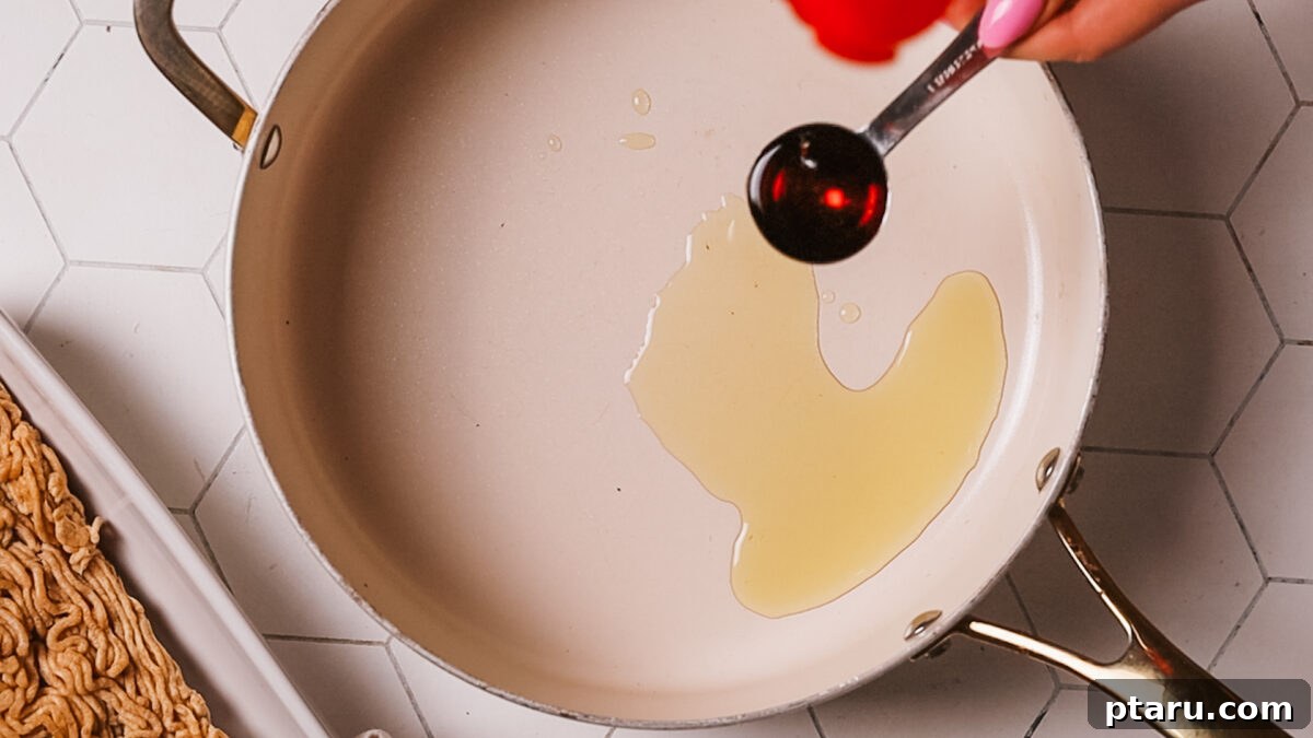 Quick Fix Egg Roll Bowl 5 Heating neutral and sesame oil in a large skillet or wok over medium-high heat.