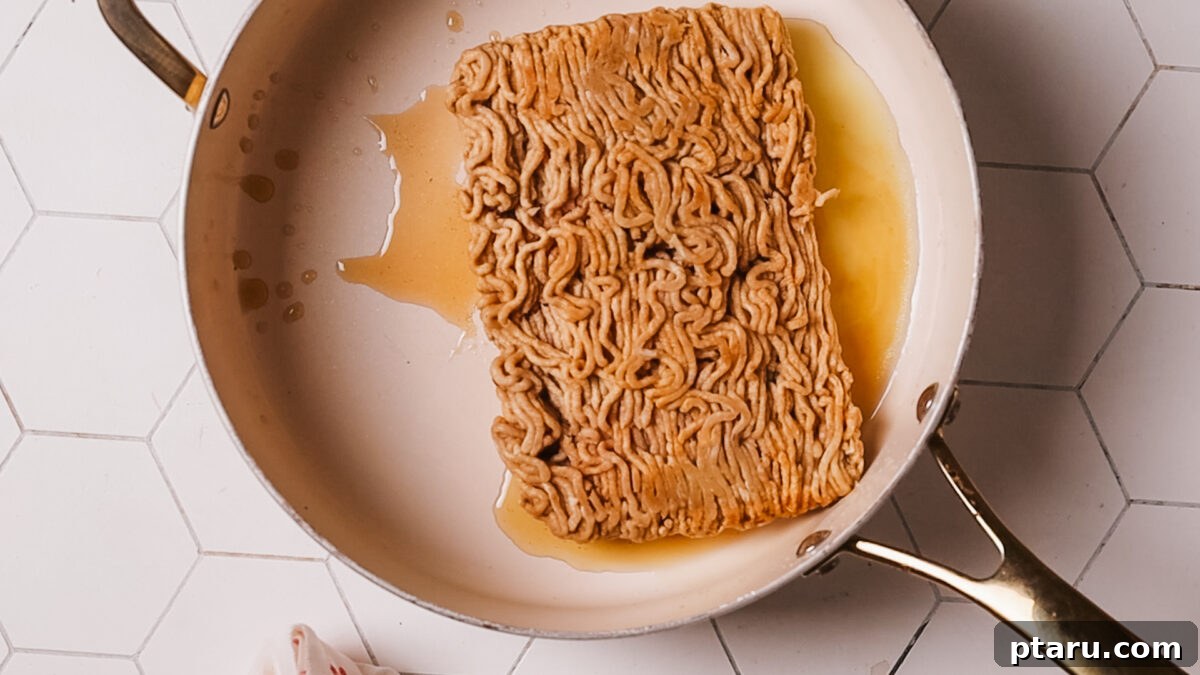Quick Fix Egg Roll Bowl 6 Browning ground chicken or pork in the skillet, breaking it up with a spatula until crispy.