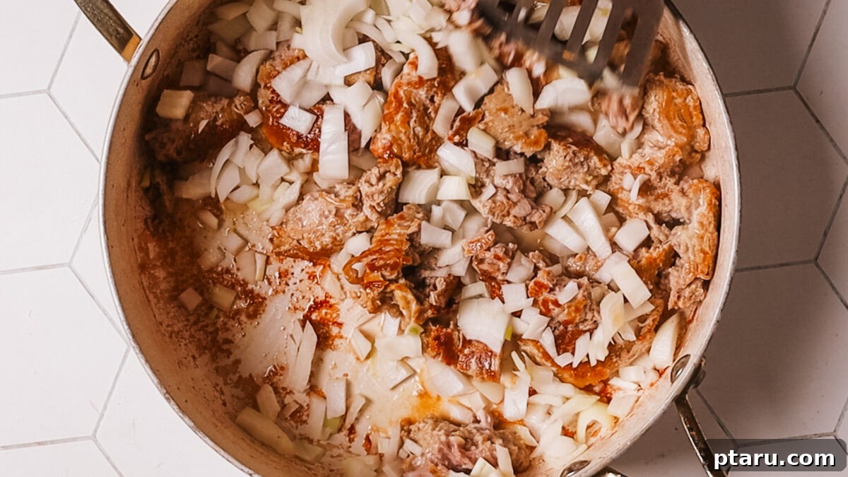 Quick Fix Egg Roll Bowl 7 Sautéing finely chopped onion, minced garlic, and freshly grated ginger with the browned meat.