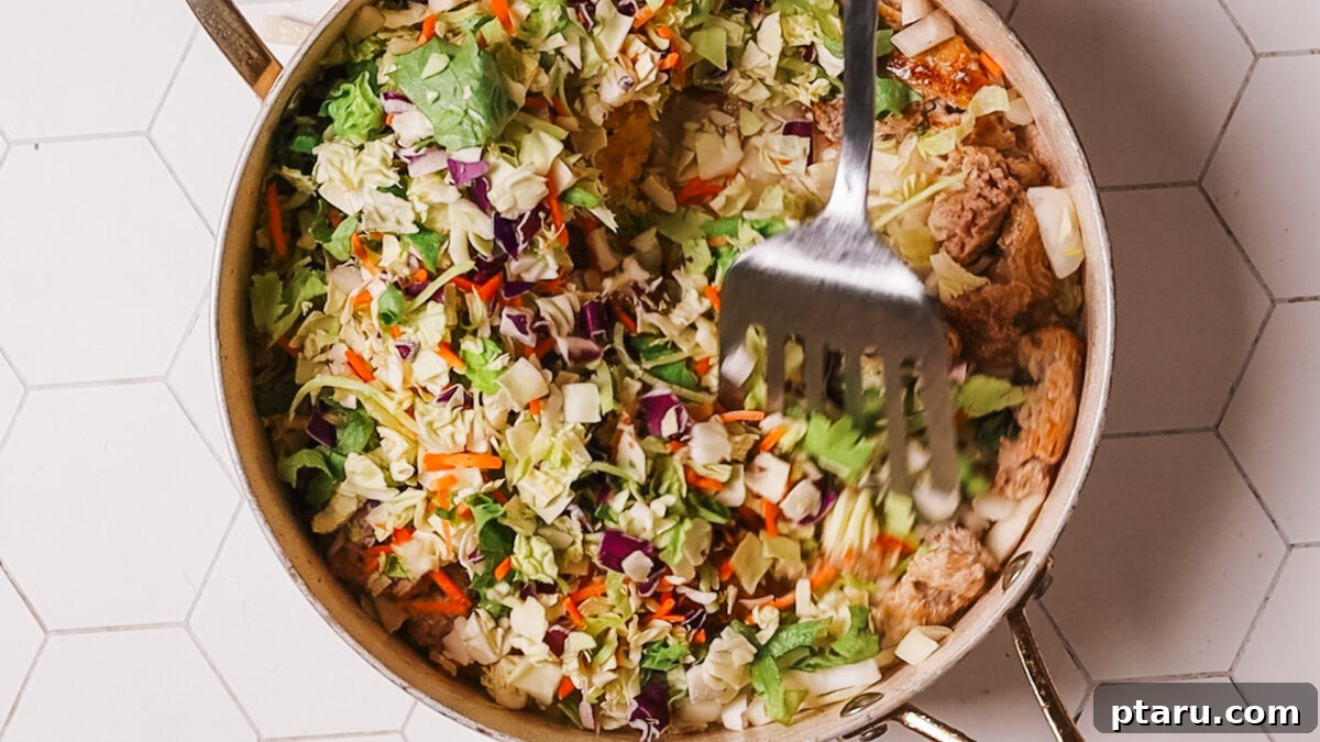 Quick Fix Egg Roll Bowl 8 Adding coleslaw mix or shredded cabbage and carrots to the pan with the meat and aromatics.