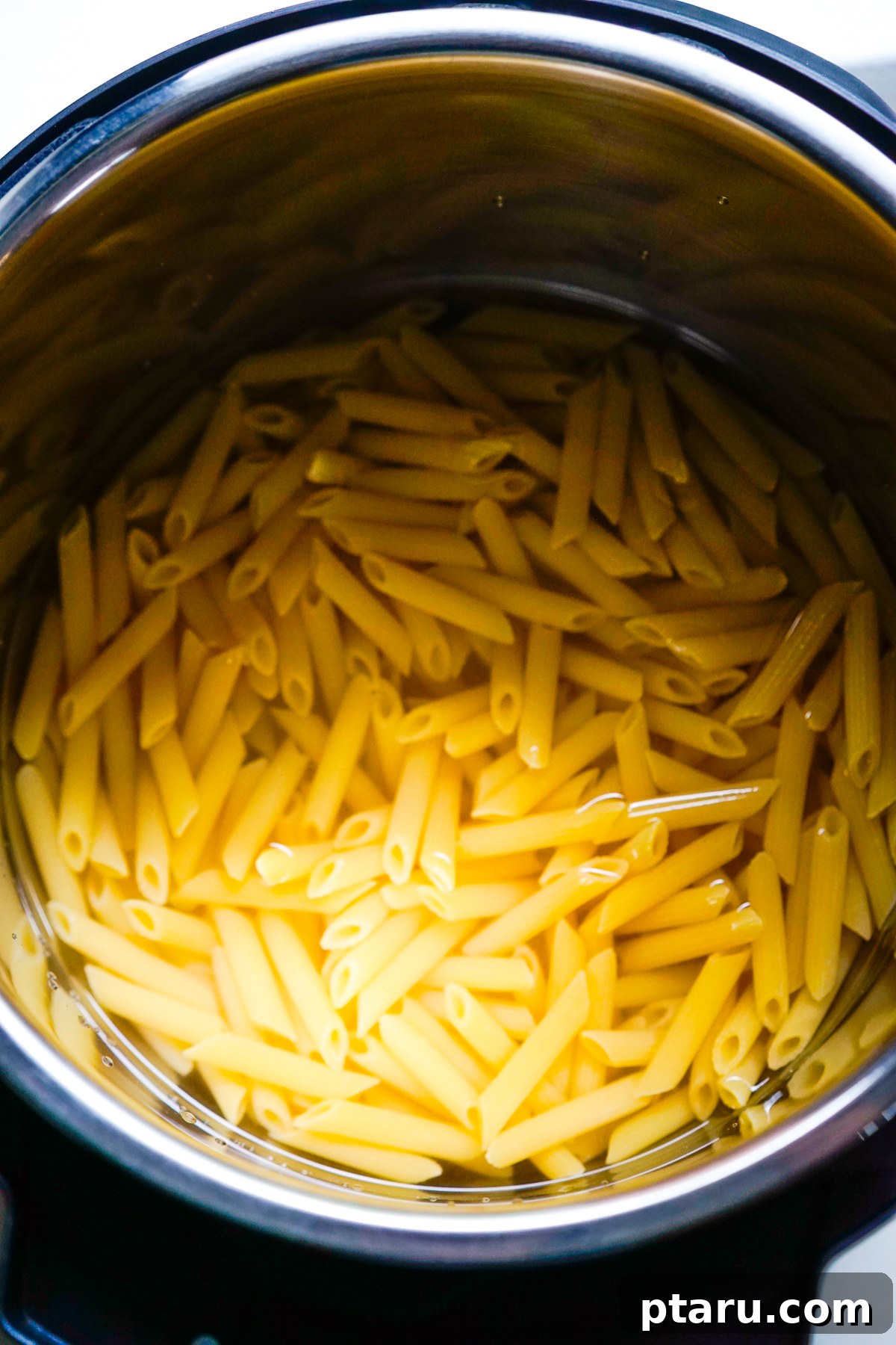 Instant Pot Pasta Perfection 4 Pasta arranged in the Instant Pot with liquid