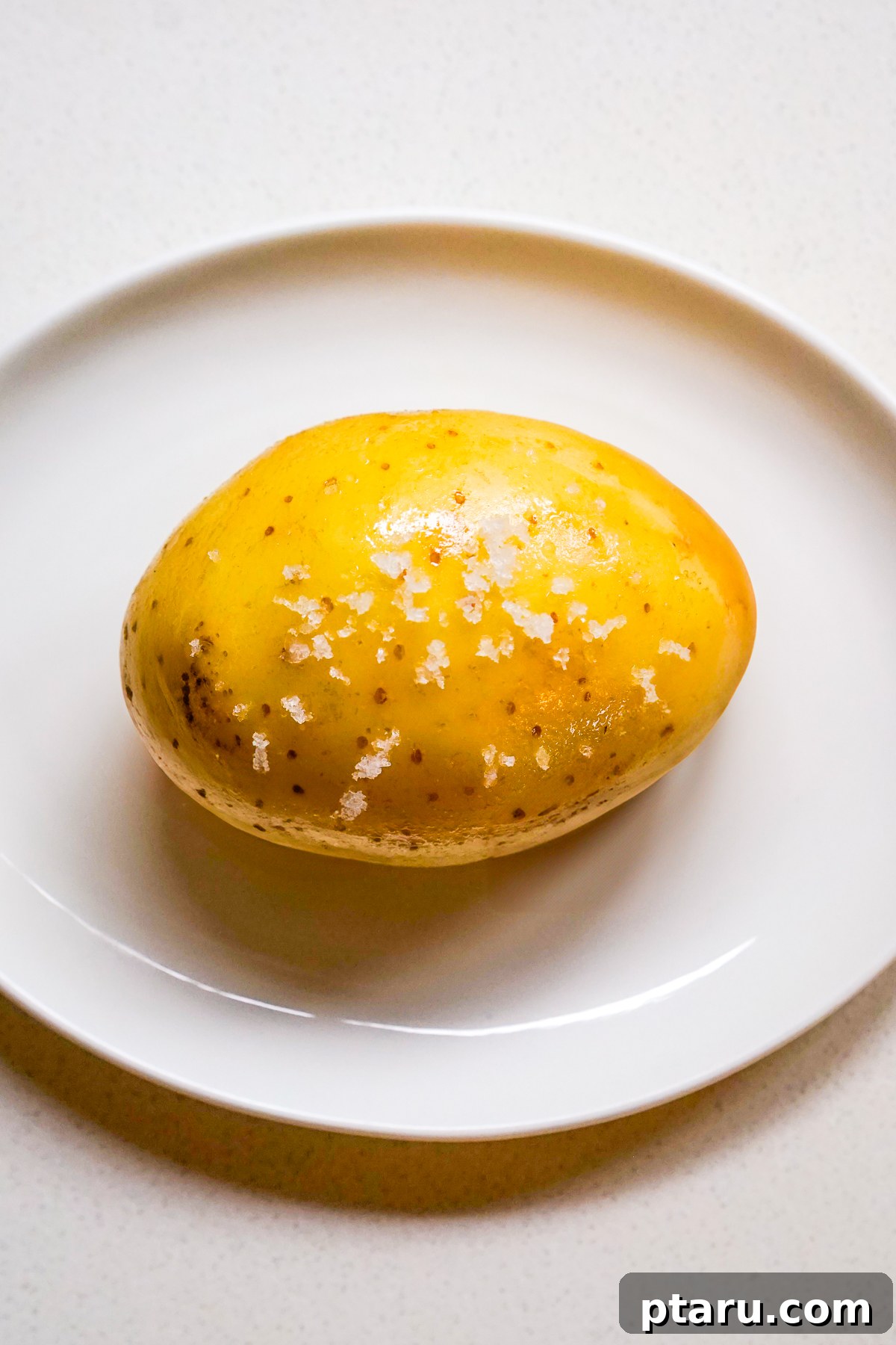 The Secret to Perfect Microwave Baked Potatoes 4 Potato with salt on top, ready for microwaving