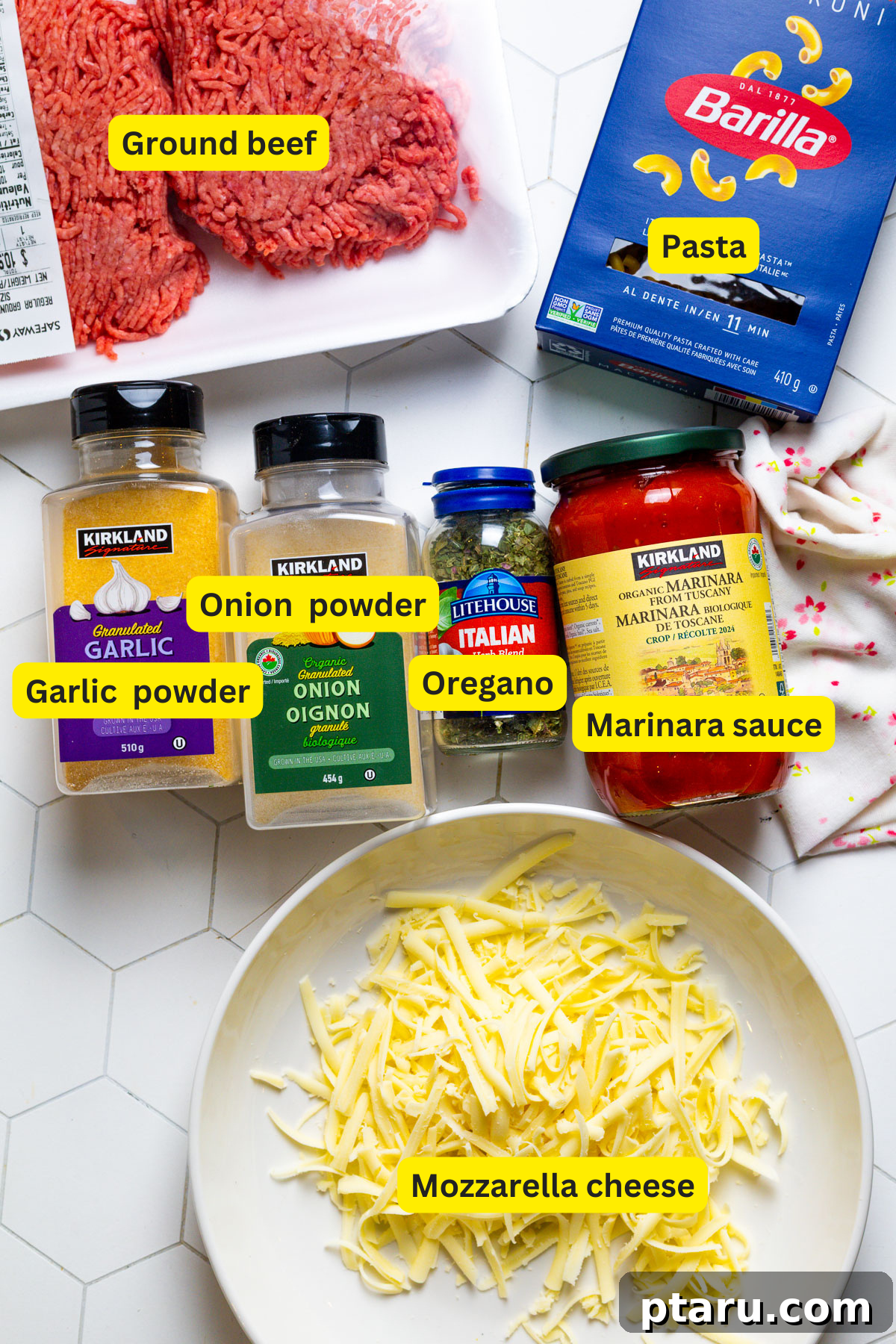 Classic Comfort Hamburger Bake 3 Assortment of fresh ingredients laid out for making Hamburger Casserole, including pasta, marinara sauce, ground beef, spices, and mozzarella cheese.