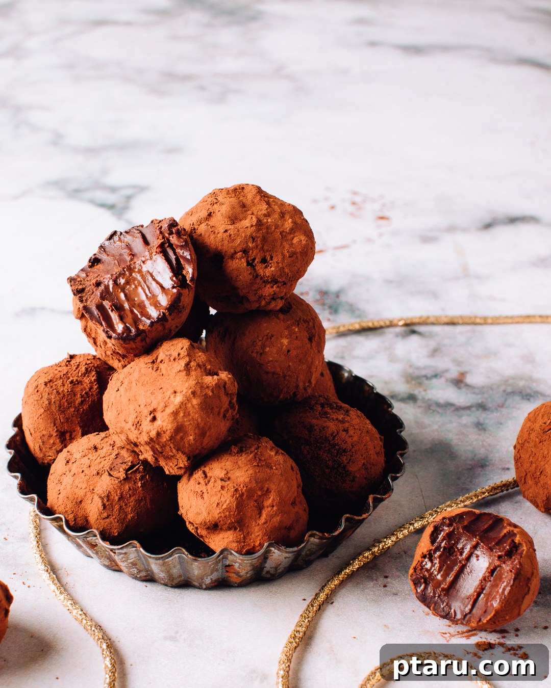 Decadent Three Ingredient Chocolate Truffles 2 A delectable pile of homemade chocolate truffles, ready to be enjoyed.