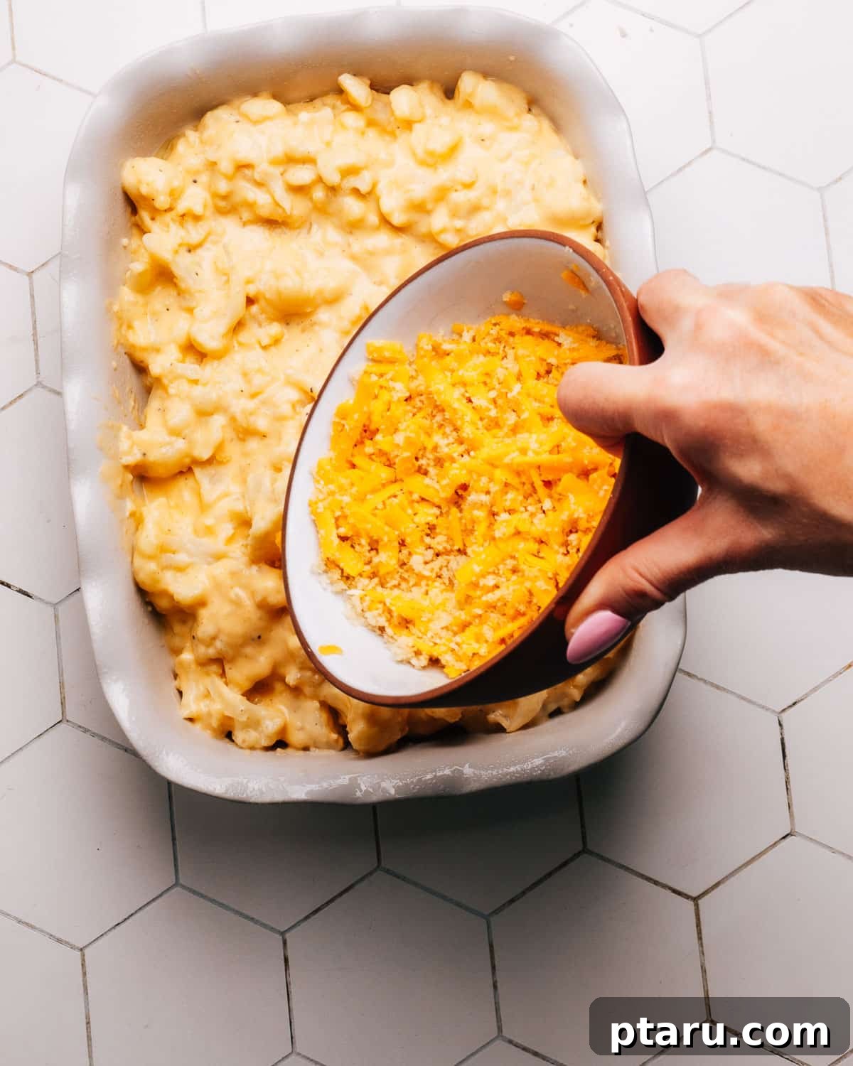 Game-Changing Cauliflower Casserole 9 A golden brown, bubbling cauliflower casserole, freshly baked with a crispy breadcrumb topping, garnished with fresh herbs.