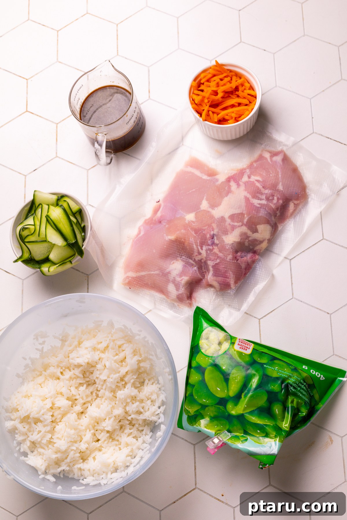 30 Minute Delicious Teriyaki Bowl 3 A collection of fresh ingredients laid out for making the teriyaki bowl, including chicken, rice, soy sauce, and vegetables.
