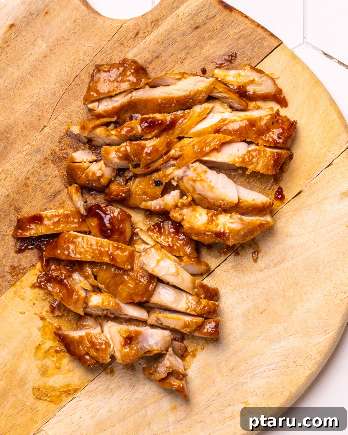 30 Minute Delicious Teriyaki Bowl 6 Step 3: Pouring teriyaki sauce over cooked chicken in a skillet.