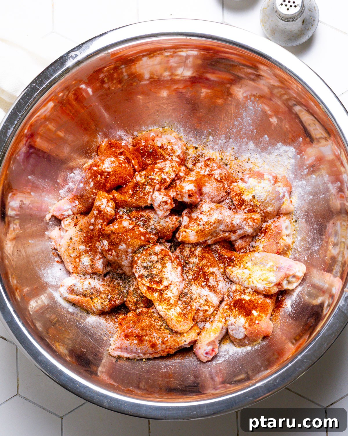 Tropical Fire Wings 4 Tossing chicken wings with seasoning