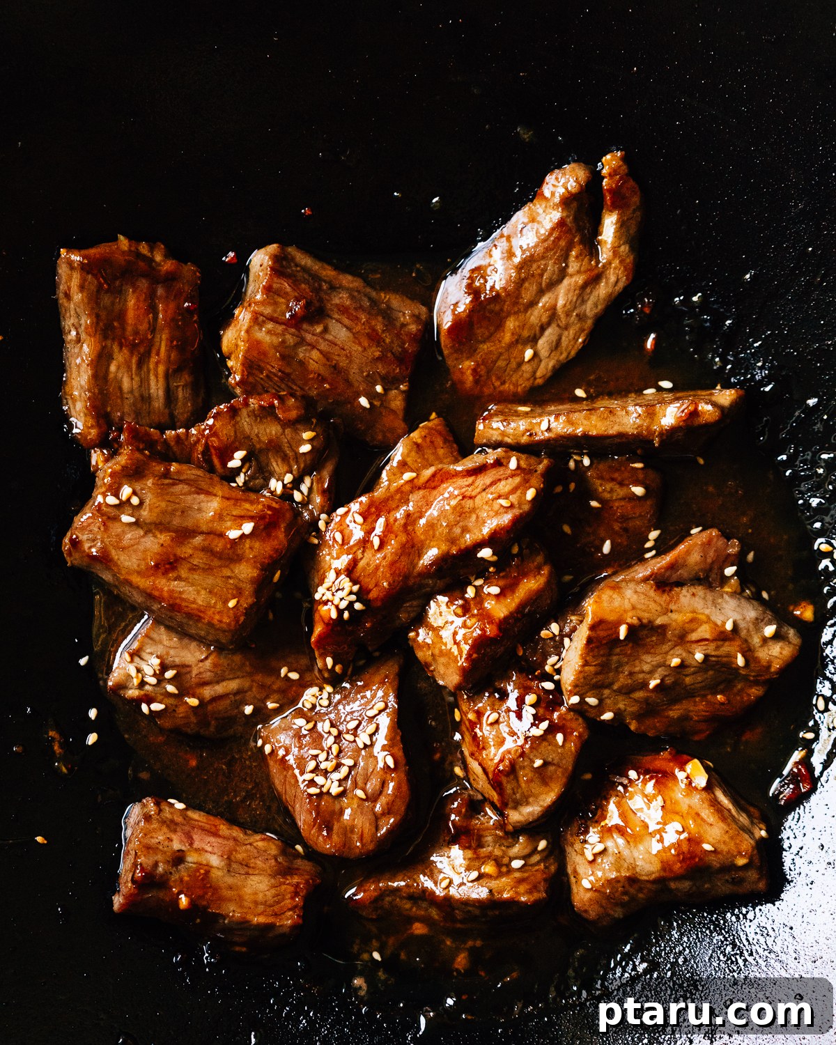 Sweet and Savory Teriyaki Beef 6 Searing beef teriyaki in a hot skillet with a glossy sauce forming.