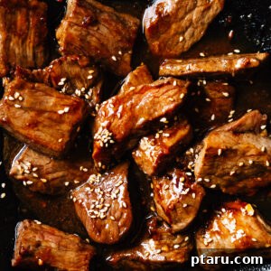 Beef Teriyaki recipe with boneless beef, garnished with sesame seeds.