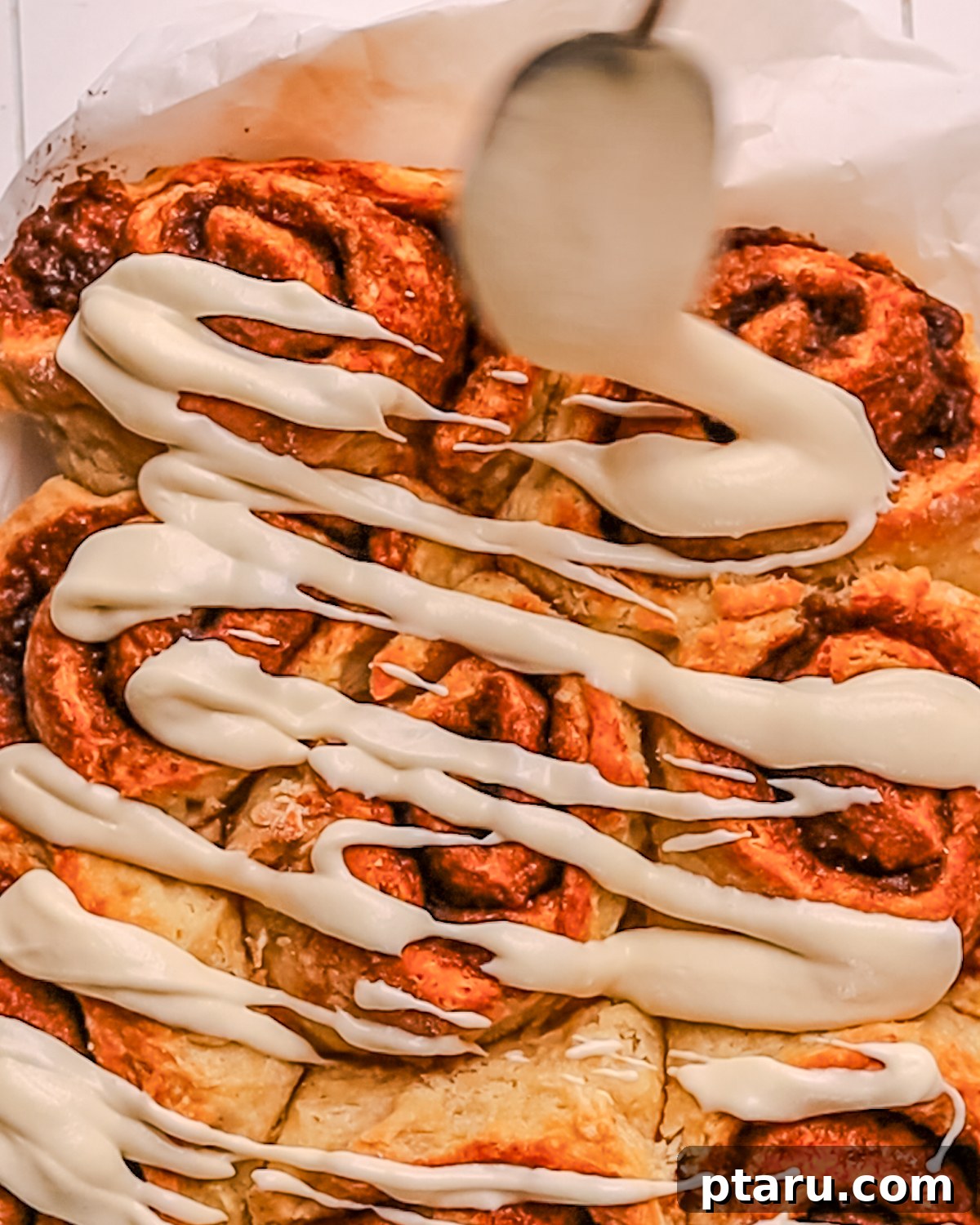 Silky Smooth Cream Cheese Frosting 8 Warm Cinnamon Rolls topped with thinned cream cheese icing.