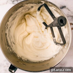 Cream Cheese Icing Recipe in a mixing bowl, showing the final fluffy product.