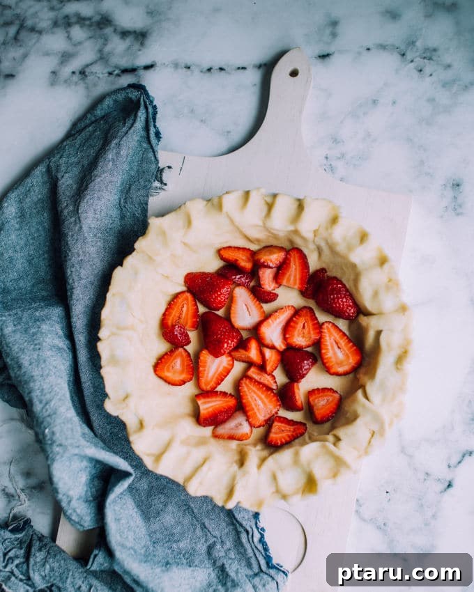 Velvet Strawberry Buttermilk Pie 3 A playful scene depicting a young child's hand reaching for a slice of Strawberry Buttermilk Pie, conveying the chaotic yet joyful essence of traveling with many young children.