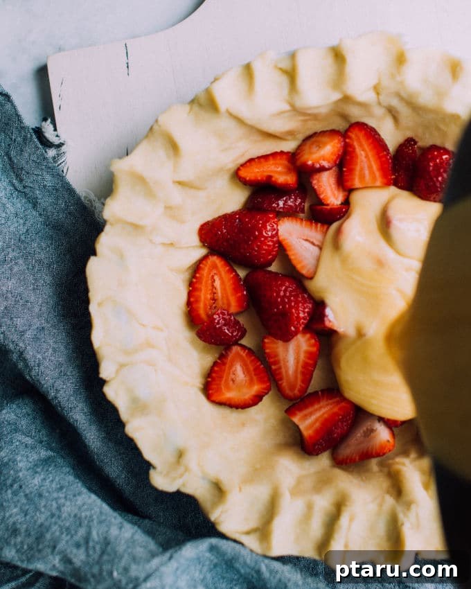 Velvet Strawberry Buttermilk Pie 5 Freshly harvested, vibrant red strawberries in a rustic basket, highlighting the beauty of seasonal produce ready for baking.