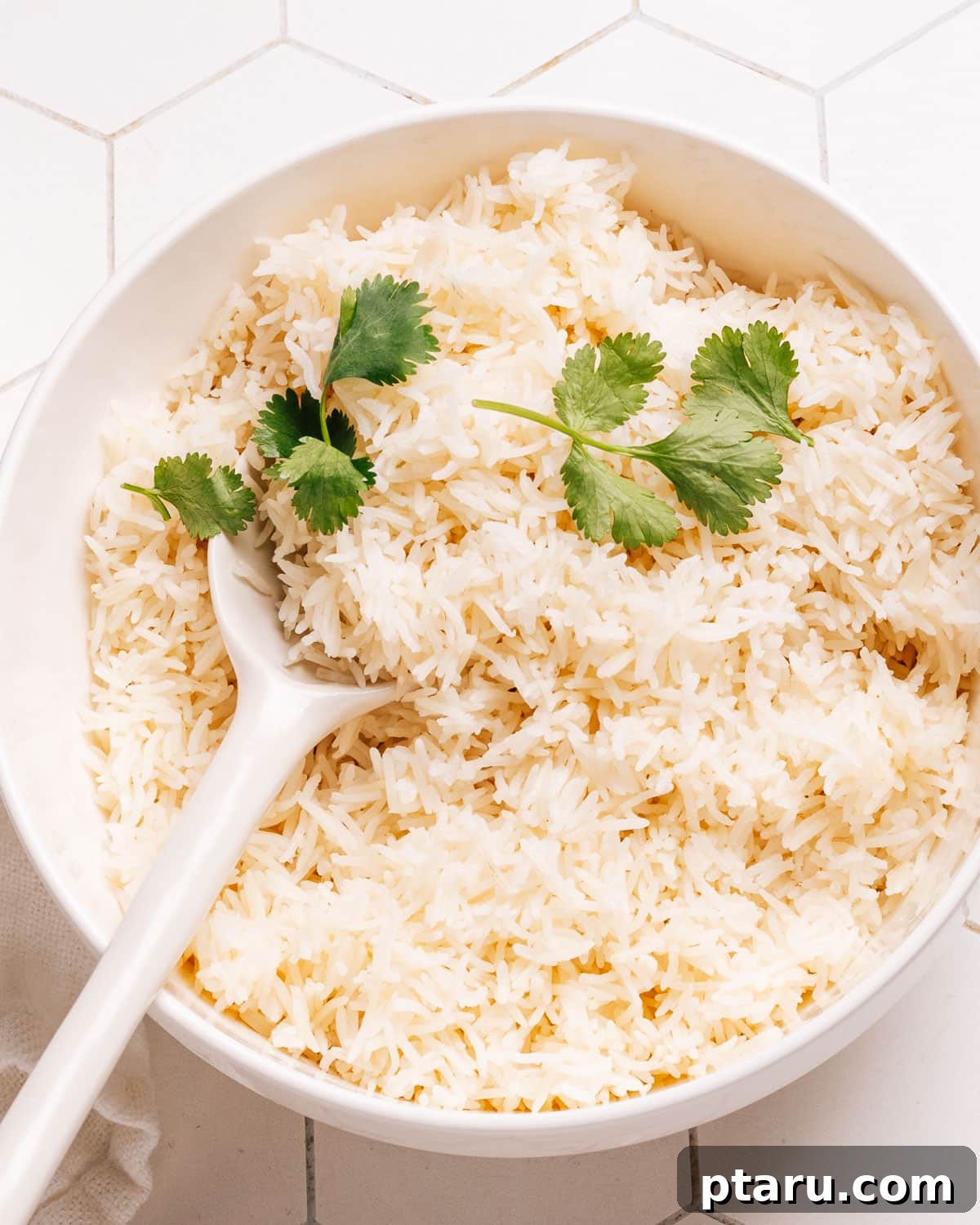 Easy Fluffy Microwave Rice 2 Microwave rice in a bowl topped with cilantro.